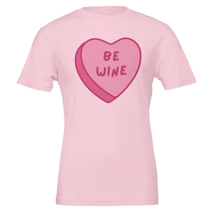 Light pink T-shirt with a pink candy heart that says "Be Wine," perfect for wine lovers and Valentine's Day celebrations.