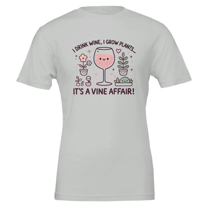 Light Gray T-shirt featuring a cute, cartoon-style design of a smiling wine glass surrounded by happy potted plants with the phrase "I drink wine, I grow plants... It's a Vine Affair!"