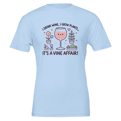 Light Blue T-shirt featuring a cute, cartoon-style design of a smiling wine glass surrounded by happy potted plants with the phrase "I drink wine, I grow plants... It's a Vine Affair!"