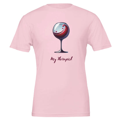 Pink T-shirt featuring a stylized illustration of a wine glass with swirling red wine and the phrase "My Therapist" in an elegant, playful font.