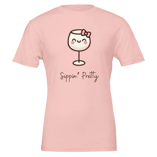 Cute pink T-shirt featuring a cartoon-style wine glass with a bow and the phrase "Sippin' Pretty" in playful font.