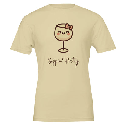 Cute tan T-shirt featuring a cartoon-style wine glass with a bow and the phrase "Sippin' Pretty" in playful font.