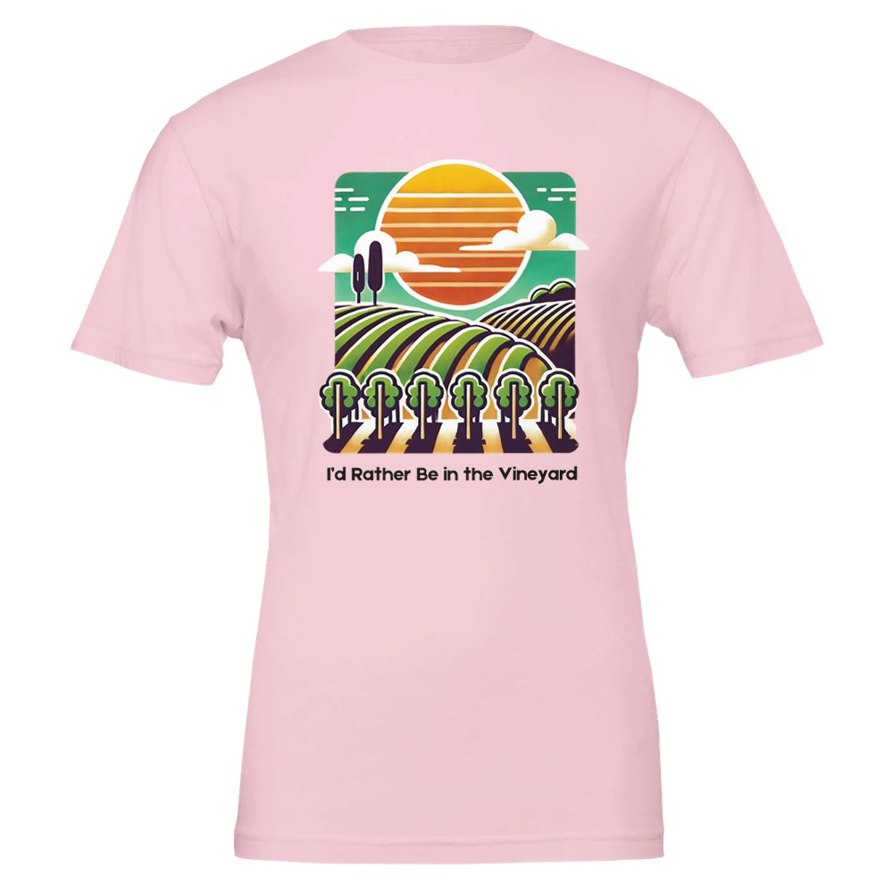 Pink T-shirt featuring a colorful illustration of a vineyard with rolling rows of grapevines under a sunset, along with the phrase "I'd Rather Be in the Vineyard", celebrating vineyard life.