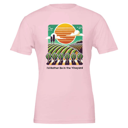 Pink T-shirt featuring a colorful illustration of a vineyard with rolling rows of grapevines under a sunset, along with the phrase "I'd Rather Be in the Vineyard", celebrating vineyard life.