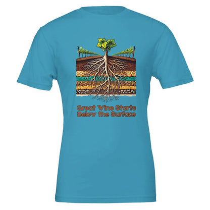 Teal T-shirt with a colorful illustration of grapevine roots extending through various soil layers, accompanied by the phrase "Great Wine Starts Below the Surface", emphasizing the importance of terroir in winemaking.