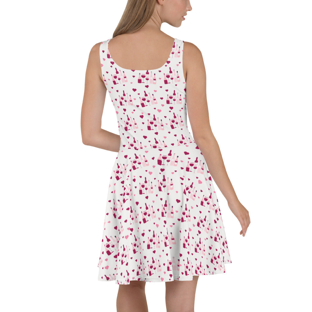 Sleeveless white dress with a red wine splash pattern, featuring flared skirt for a stylish and playful wine-inspired look.