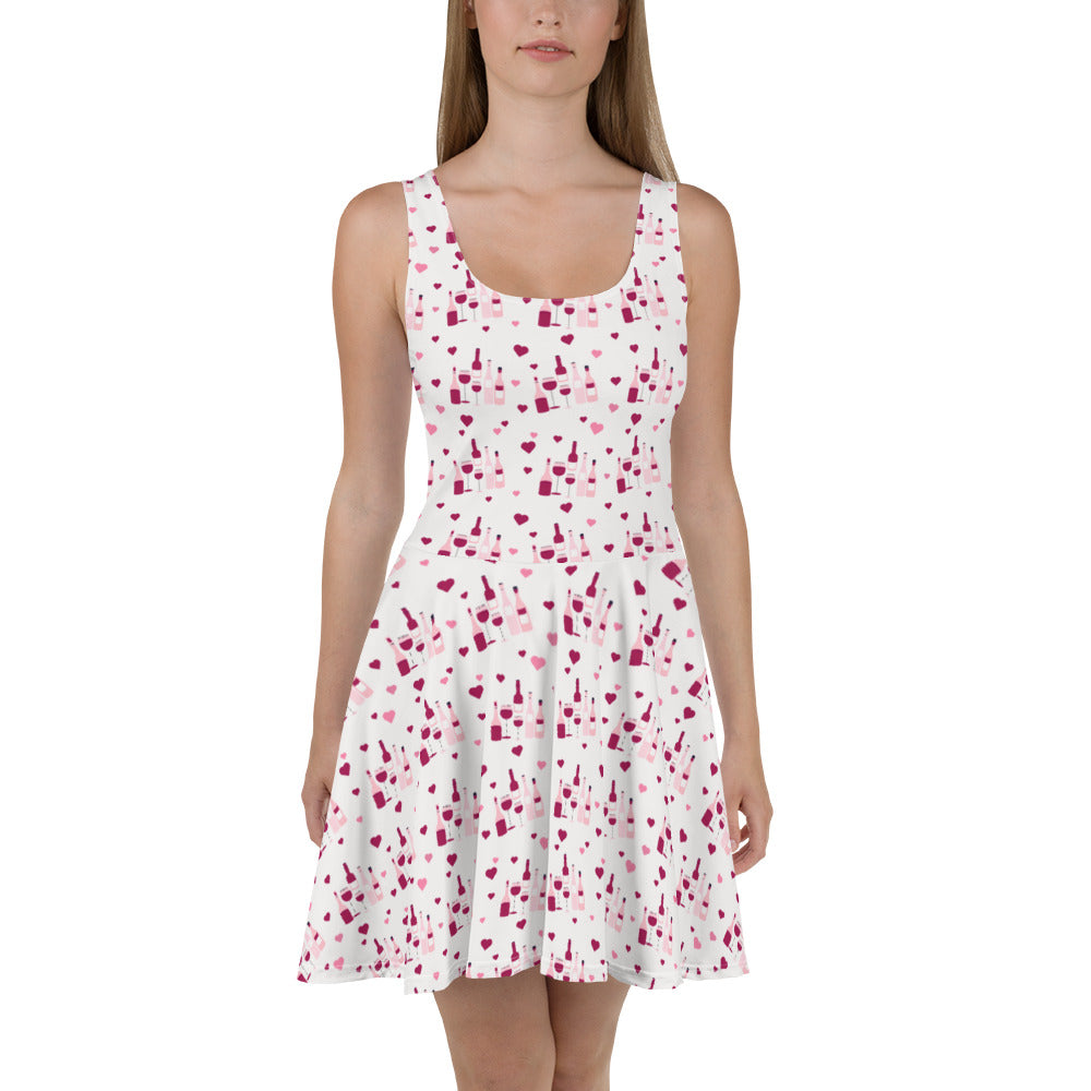 Sleeveless white dress with a red wine splash pattern, featuring flared skirt for a stylish and playful wine-inspired look.