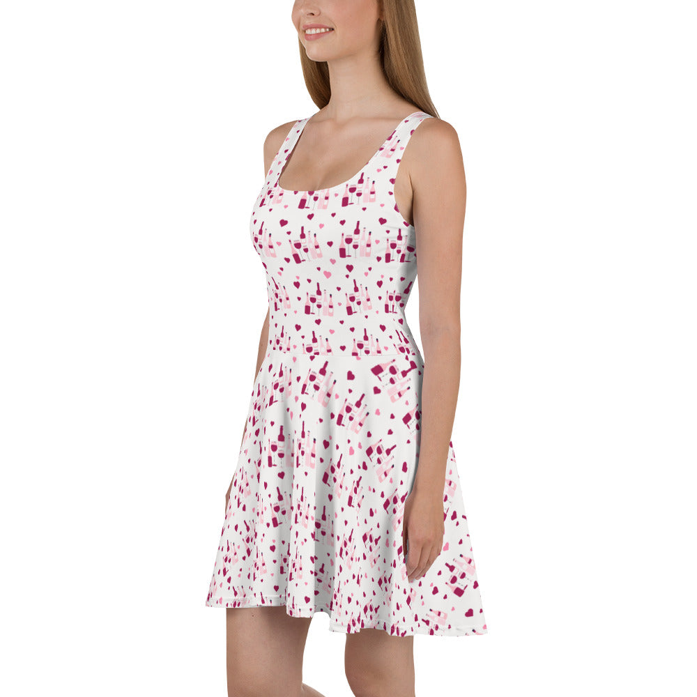 Sleeveless white dress with a red wine splash pattern, featuring flared skirt for a stylish and playful wine-inspired look.